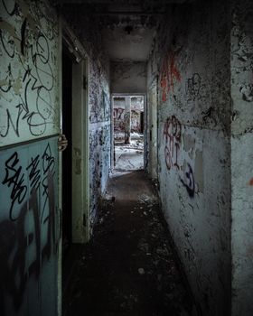 Scary abandoned corridor with hidden hand