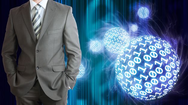Businessman in a suit. Spheres of glowing digits on background