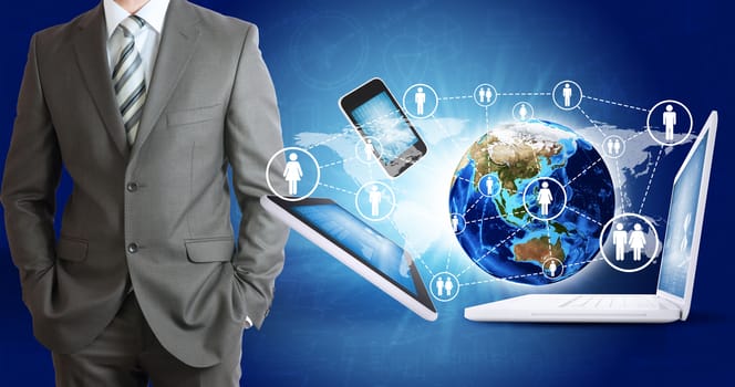 Businessman in suit. Earth and electronics. Elements of this image are furnished by NASA