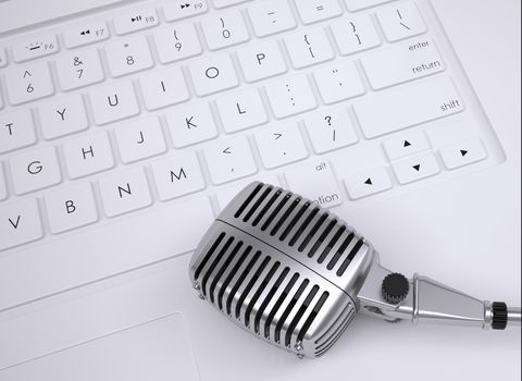 Old microphone on the keyboard. View from above