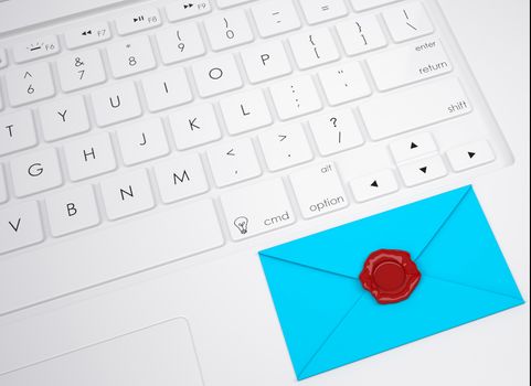 Envelope with stamp on the keyboard. View from above