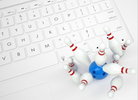 Bowling ball and skittles on the keyboard. View from above