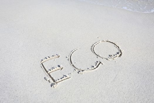 eco handwritten in sand on a beach