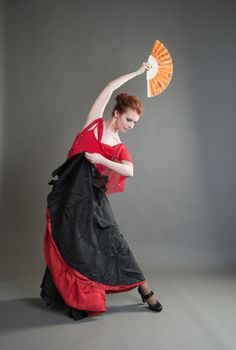 girl with a fan black skirt dancing flamenco