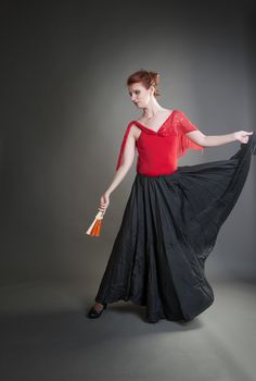 girl with a fan black skirt dancing flamenco