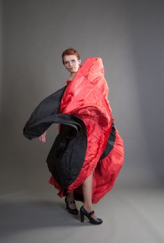 flamenco dancer swinging skirt on a grey background