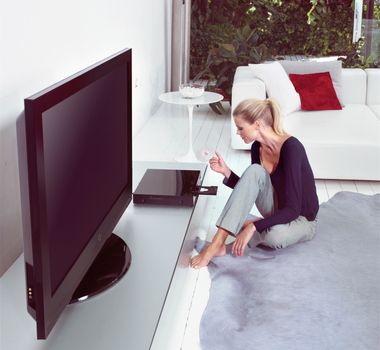 Woman in living room watching home cinema