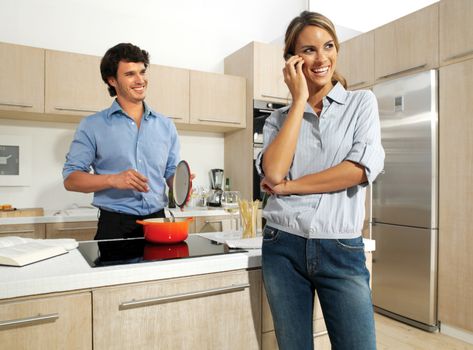 cute mature couple enjoying themselves while preparing food 