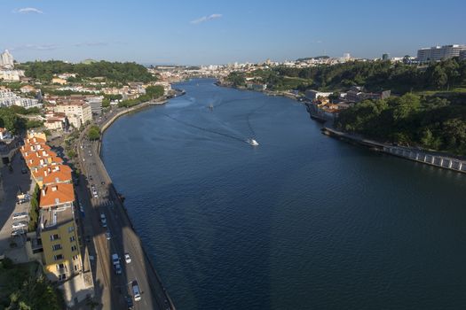 view to river with reflections and blue cloudy sky