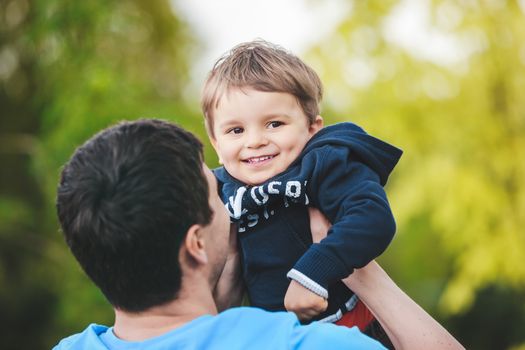 father playing with his son, focus on the son