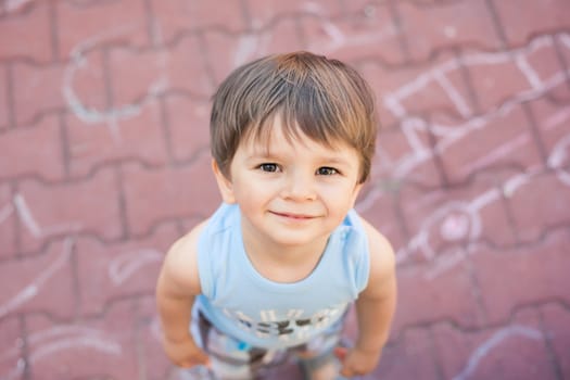 smiling small boy looking up at camera