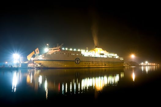 Newhaven, UK - April 15, 2011: Seven Sisters vehicle and passenger ferry docked and unloading by floodlight at the port of Newhaven, UK