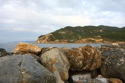 Rocks on defensive bulwark in Skopelos town on Greek island Skopelos