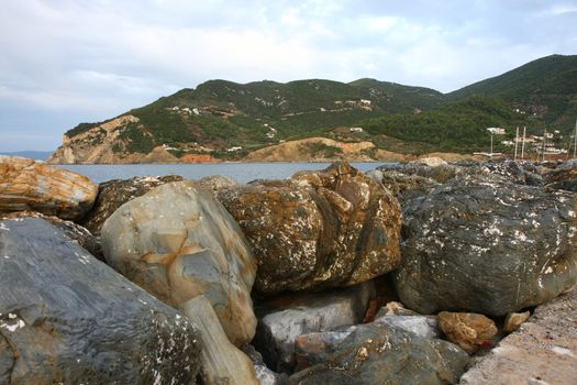 Rocks on defensive bulwark in Skopelos town on Greek island Skopelos