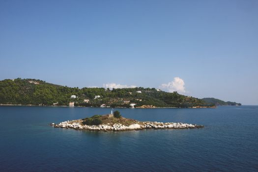 Small island close to Greek island Skiathos at Mediterranean sea