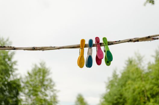 colorful shape clothes pins hanging on rope outdoor