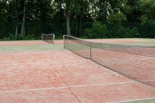 tennis courts in recreation village park in summer nature