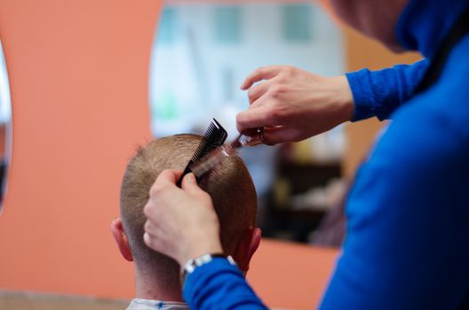 man haircut at the barber scissors at beauty salon