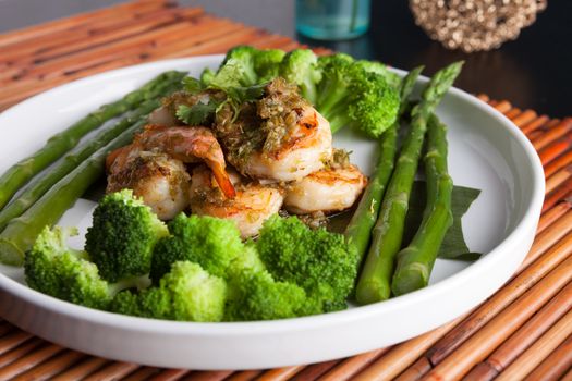 Shrimp scampi seafood dish with broccoli and asparagus.
