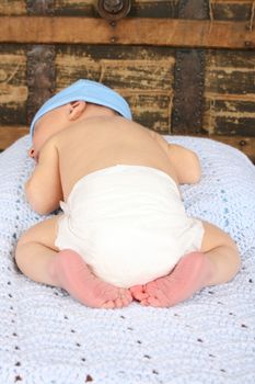 Newborn baby boy sleeping on a blue blanket