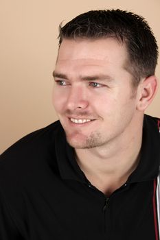 Attractive brunette male against a light background
