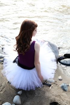 Beautiful girl wearing a white tutu by the river