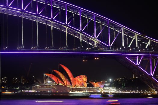 NTH SYDNEY, AUSTRALIA - JUNE 7, 2014; Sydney Harbour Bridge and Opera House in vibrant colours during Vivid Sydney annual festival celebrations.