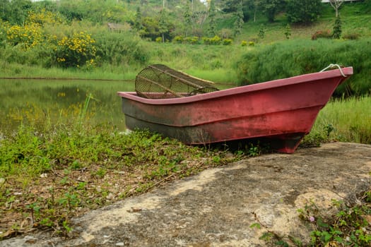 the old plastic boat on the shore of the rever