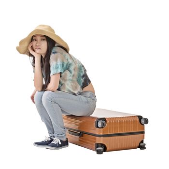 Asian woman thinking and sitting on a luggage, full length portrait isolated on white background.