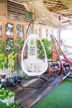 White hanger chair in relaxing corner, stock photo