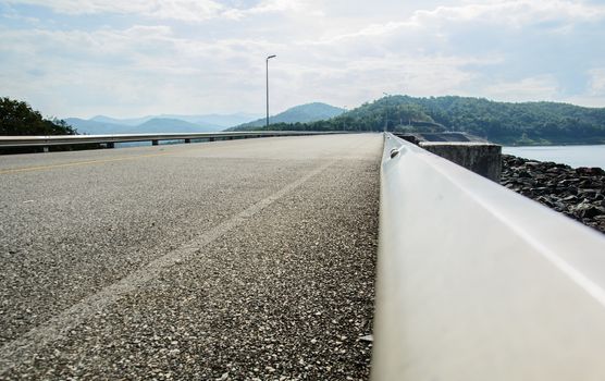 The empty road at the country side directs to the city