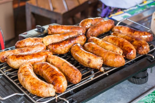 Grilled spicy sausages on the stove, stock photo