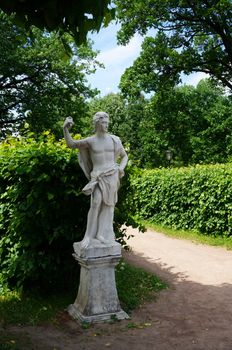 White marble statue in a summer park                               