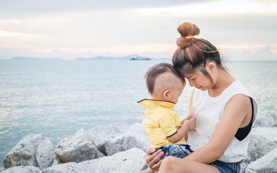 Cute asian boy playing with his mother, stock photo