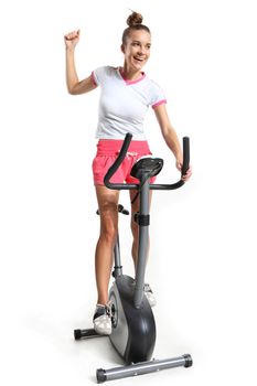 Woman on exercise bike pedals