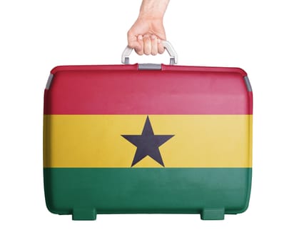 Used plastic suitcase with stains and scratches, printed with flag, Ghana