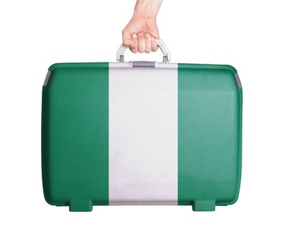 Used plastic suitcase with stains and scratches, printed with flag, Nigeria