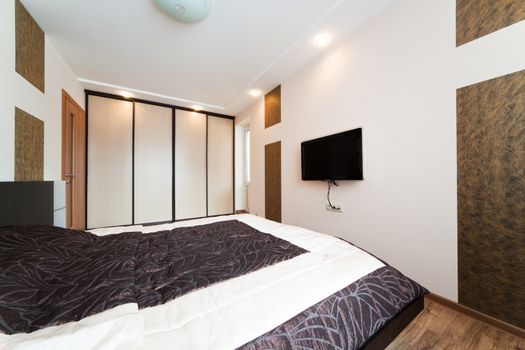 Beautiful wide bed in a modern bedroom