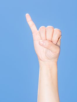 the hand with reconciliation sign under the beautiful blue sky