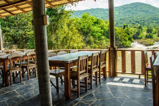 A beautiful nature view on the side of the restaurant. Classic wooden seats in the restaurant.