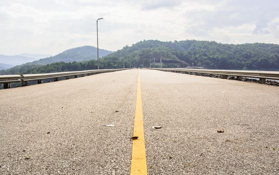 Straight road on the country side connecting to the big city