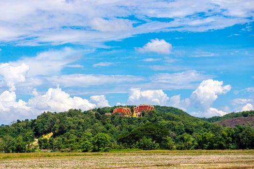 nature landscape at rural area of Thailand that show the temple on mountain among rice fields,Chiangrai,Thailand