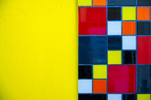 two texture of mosaic tile and bright yellow concrete wall,shallow focus