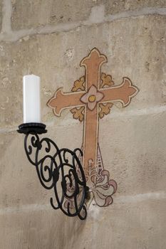 Sconce and cross - detail of the interior decorating Saint Barbara Church in Kutna Hora -  one of the most famous Gothic churches in central Europe and it is a UNESCO world heritage site.