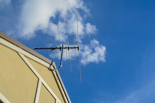 the tv antenna is installed up on the top roof of the house.