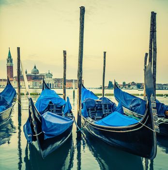 Gondolas floating in the Grand Canal at sunset, special photographic processing.