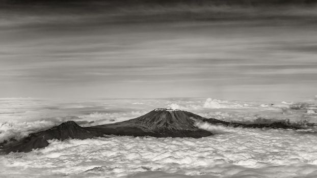 The tallest mountain in Africa, Mount Kilimanjaro, soaring above the clouds