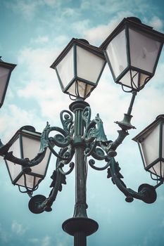 romantic, traditional street lamp with decorative metal flourishes