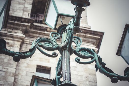 outdoor, traditional street lamp with decorative metal flourishes