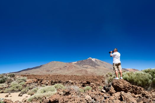 Man taking picture near Teide Volcano, Tenerife Island, Spain